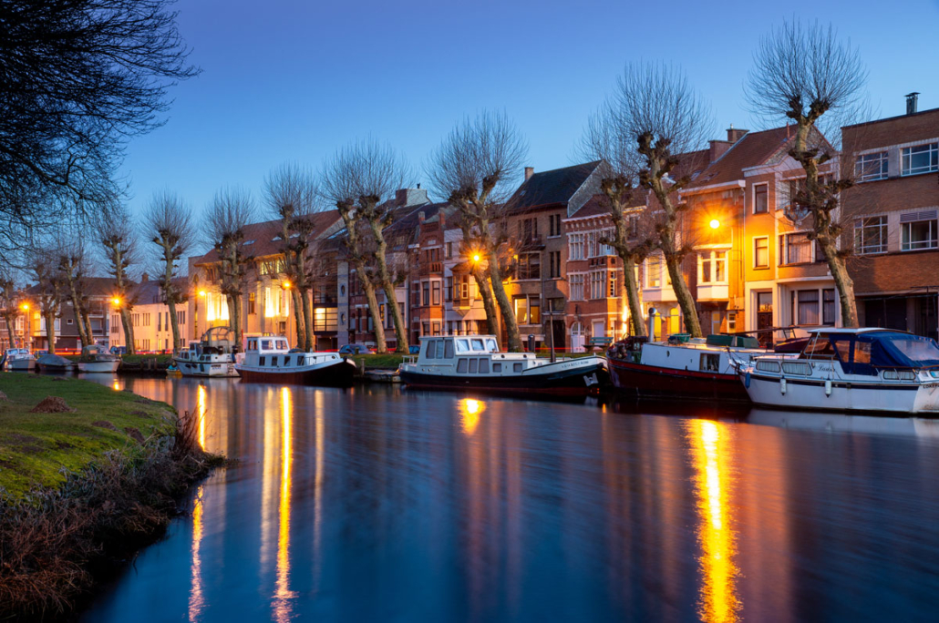 Photography project of the river Durme with boats on the river at blue hour