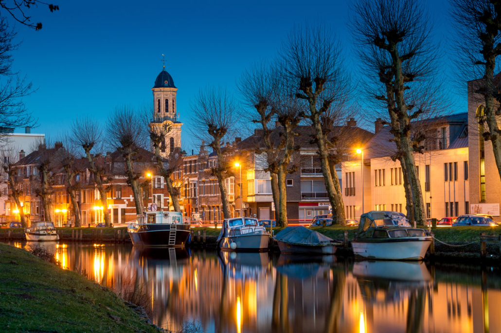 Photography project of the river Durme with boats on the river at blue hour